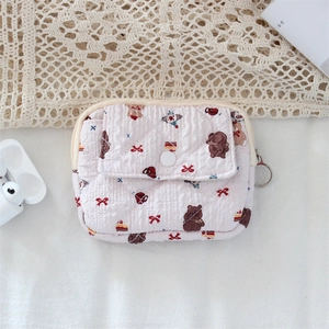 Detail view of pink quilted cartoon bear coin purse with button pocket and metal hook
