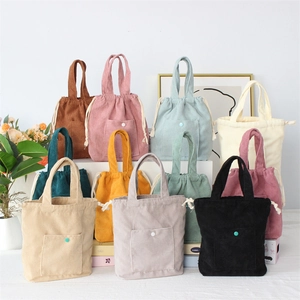 Detailed row of colorful corduroy drawstring handbags with front snap buttons