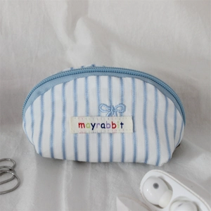 Detail of blue striped cotton shell pouch with butterfly embroidery and metal chain