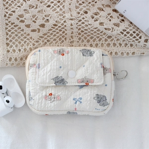 Detail of quilted cartoon elephant coin purse with flap pocket and silver metal hook