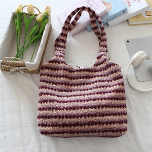 Detailed top view of a plush striped tote bag with red and pink faux fur texture