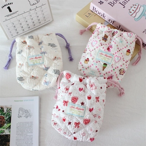 Quilted cartoon storage bags with drawstring closure showing soft texture and patterns
