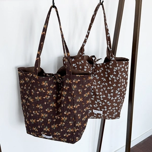Floral print tote bags with quilted texture and Magic Pocket label on white background