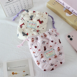 Detail of quilted cotton drawstring bags featuring dalmatian and teddy bear patterns