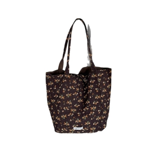 Quilted floral tote bag in dark brown with orange flowers and Magic pocket label