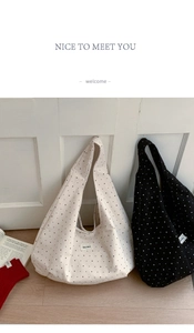 Detailed view of canvas tote bags with polka dots and star patterns on wooden floor