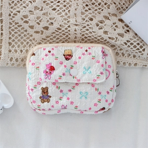 Quilted white storage pouch with cute bear and floral prints and a front snap pocket