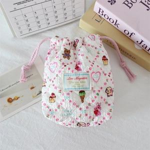 Detail of quilted camera storage pouch with cute cartoon patterns and pink drawstring