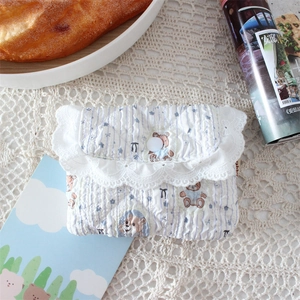Detail of quilted cotton coin purse with blue stripes, bear prints and lace trim