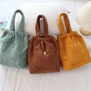 Corduroy drawstring handbags in vintage green, caramel, and yellow with front button pocket