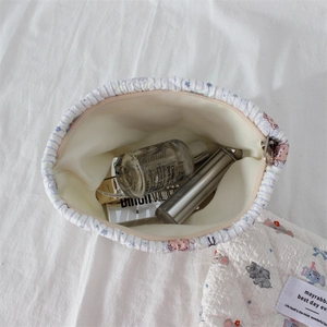 Quilted makeup bag open view with cute elephant patterns and ample storage space