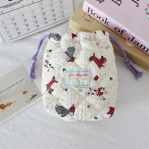 Close-up of quilted cotton drawstring camera bag with cute cartoon puppy patterns