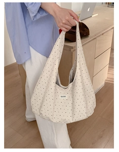 Close-up of beige polka dot canvas bag showing large capacity and Beyou Merci label detail