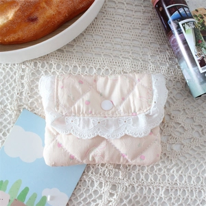 Detailed view of pink quilted mini pouch featuring strawberry rabbit print and lace trim