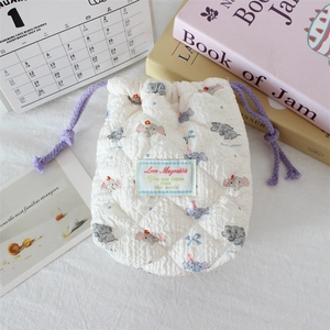 Close-up of quilted cotton camera pouch with cartoon elephant print and purple drawstring