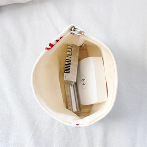 Detail view of large capacity satin jacquard makeup pouch with smooth metal zipper
