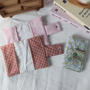 Close-up of floral fabric book covers with quilted texture and snap button closure