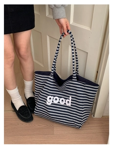 Detail of navy stripe canvas tote bag with good text print on large shoulder bag