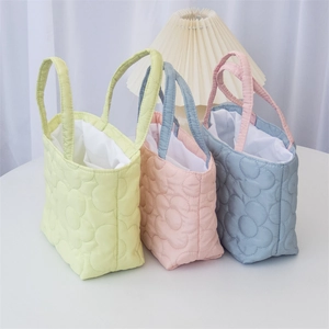 Close-up of floral quilted tote bags in yellow pink and blue pastel colors for moms