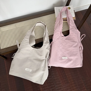 Large nylon tote bags for women in off-white and pink, featuring side drawstring details