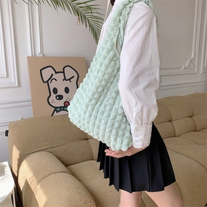 Detail of mint green popcorn textured tote bag showing 3D bubble fabric on shoulder