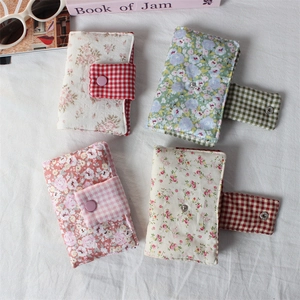 Flat lay of floral fabric book covers in four colors with plaid magnetic buckles