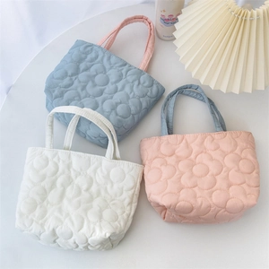Quilted floral handbag organizer in blue, pink, and white with contrast handles