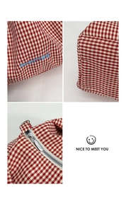 Detail of red gingham tote bag featuring blue GoodThing embroidery and silver zipper