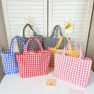 Japanese style checkered tote bags in five colors on a white table with floral decor