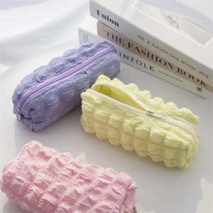 Quilted puffer stationery pouch in pink, purple, and beige with soft textured fabric