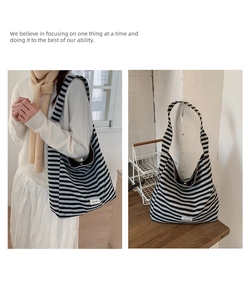 Detailed macro view of black and grey striped canvas tote bag with soft fabric texture
