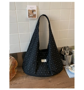 Close-up of black star pattern canvas tote bag showing the textured fabric and label