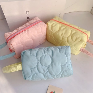 Quilted floral makeup bags in pink, yellow and blue with zipper and carry handles