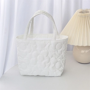 Detailed quilted texture with large flower patterns on a white soft cotton tote bag