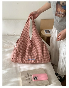 Detailed embroidery of Blue 'GoodThing' text on red plaid canvas tote bag