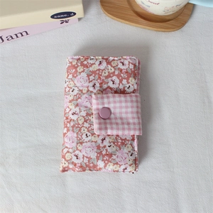 Close-up of floral fabric book cover featuring padded cotton and a matte purple button