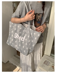 Close-up of grey star print canvas tote bag with good text detail and large capacity