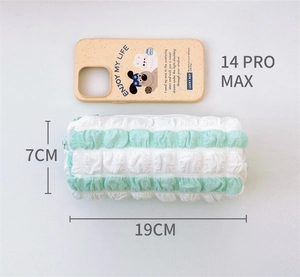 Detail of green striped quilted pencil pouch showing soft texture and 19cm length