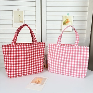 Close-up of pink and red gingham lunch bags featuring classic Japanese plaid patterns