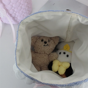 Top view of sweet lace fabric storage basket showing spacious blue striped cotton lining