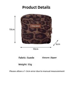 Detail view of leopard print suede mini square pouch with zipper and brand label