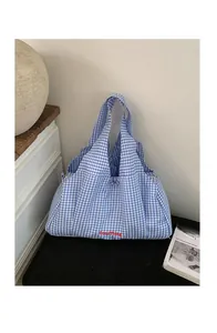 Detail of blue and white checkered tote bag with GoodThing embroidery on soft canvas fabric