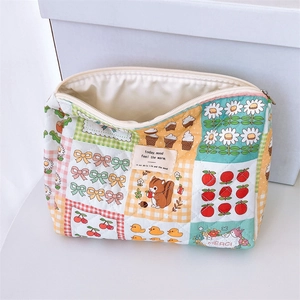 Detail of floral quilted cotton makeup bag featuring colorful patchwork and zipper closure
