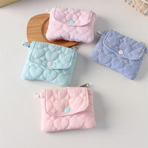Detailed view of quilted heart coin purses in pastel colors with snap and zipper closure
