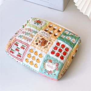 Close-up of quilted floral cosmetic bag featuring mixed patterns and cotton texture