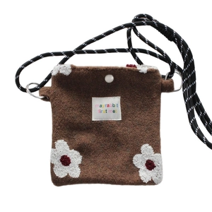 Brown felt crossbody bag with embroidered white flower and woven striped rope strap