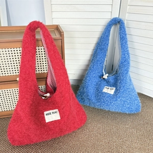 Winter plush tote bags in red and blue faux fur with reversible plaid lining and wood toggle