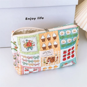 Quilted floral makeup bag with patchwork animal prints and a silver zipper closure