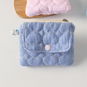Detailed view of quilted blue striped coin purse with pink snap button and zipper closure