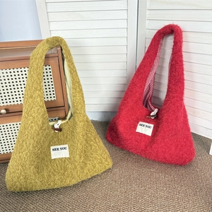 Detailed plush tote bag showing wood horn button and SEE YOU tag with plaid lining